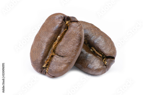 Two roasted coffee beans isolated on white background. photo