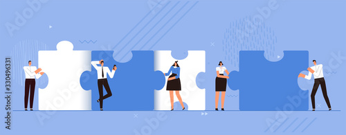 The business team makes together big pieces of puzzles. The concept of successful teamwork, cooperation and cooperation. People work together