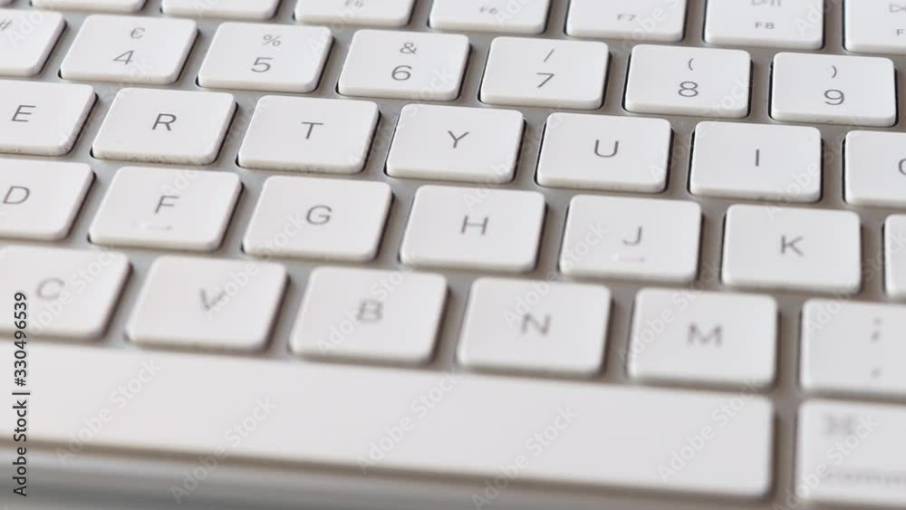 Slow pan along keys on white computer keyboard, close-up Slow pan along keys on white computer keyboard, close-up