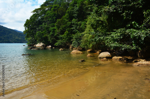 Ribeira beach in Ubatuba, Brazil, clear water, forest, rocks