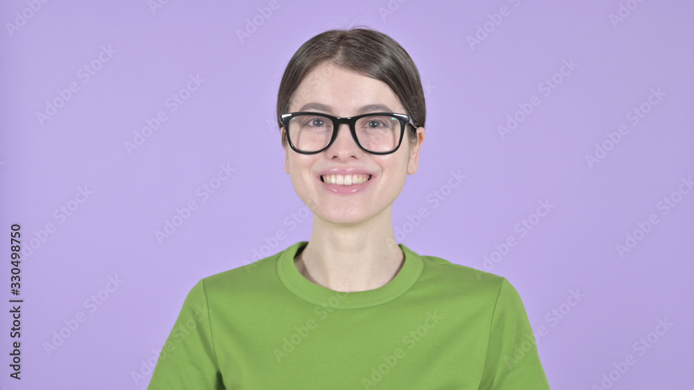 The Cheerful Woman Smiling at Camera on Purple Background The Cheerful Woman Smiling at Camera on Purple Background