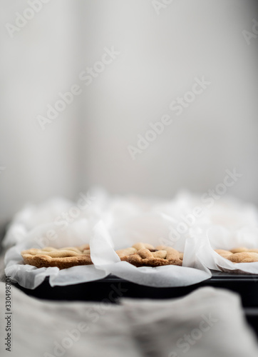 Three little home made apple pie in white baking paper