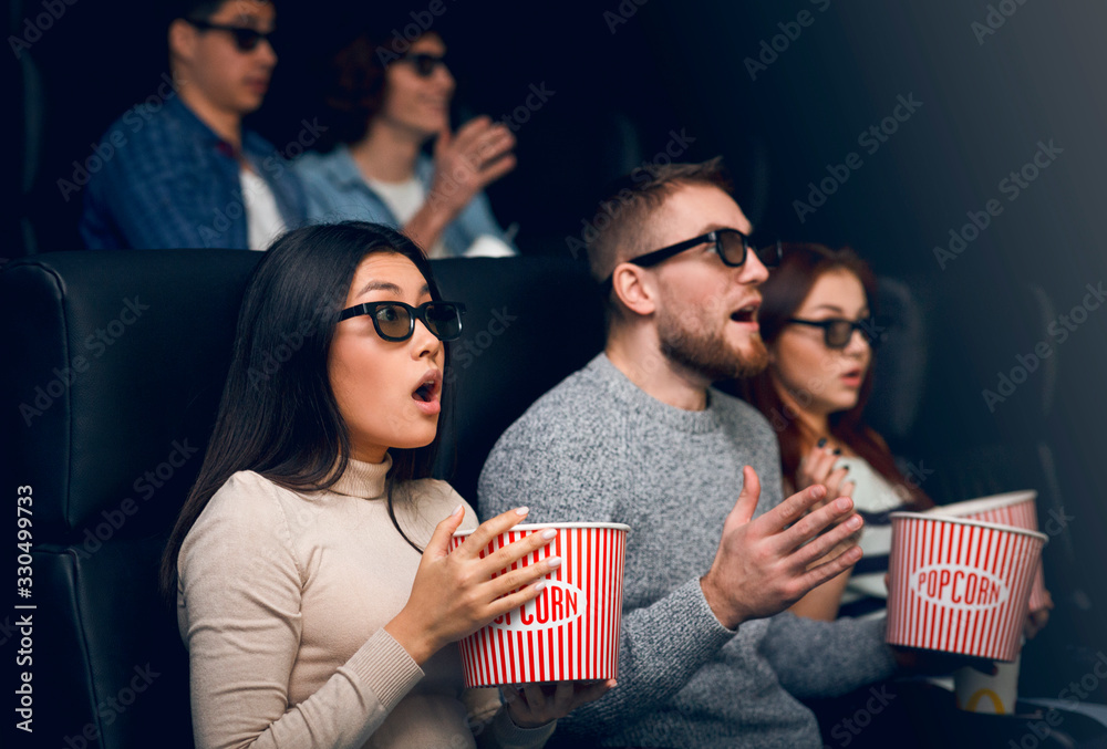 Bewildered people scared of 3D thriller in movie theater Bewildered people scared of 3D thriller in movie theater