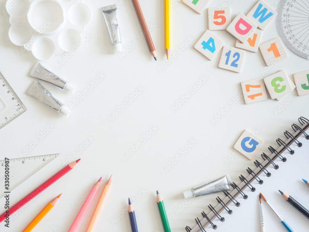 Back to school concept and artist kid concept with Drawing book, crayons, coloured pencils, Poster color and School stationery on white wooden background with copy space Back to school concept and artist kid concept with Drawing book, crayons, coloured pencils, Poster color and School stationery on white wooden background with copy space