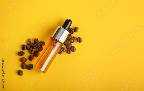 Oil for care with coffee on yellow background