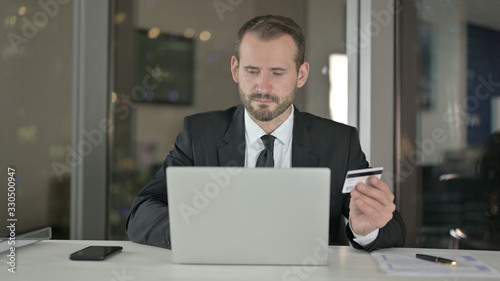 The Businessman using Credit Card for Shopping at Night