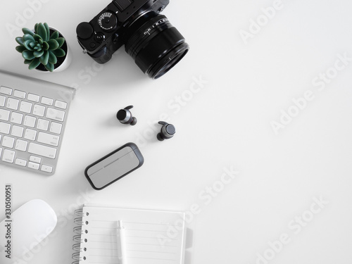 top view of office desk table with calculator, notebook, plastic plant, smartphone and keyboard on white background, graphic designer, Creative Designer concept.