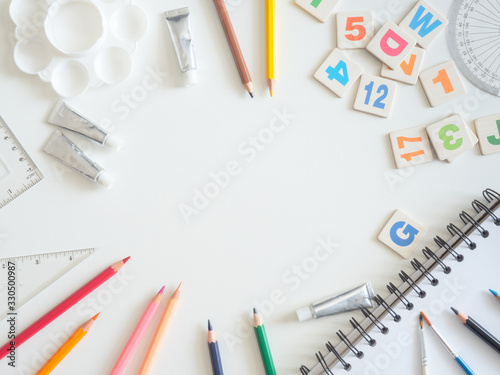 Back to school concept and artist kid concept with Drawing book, crayons, coloured pencils, Poster color and School stationery on white wooden background with copy space
