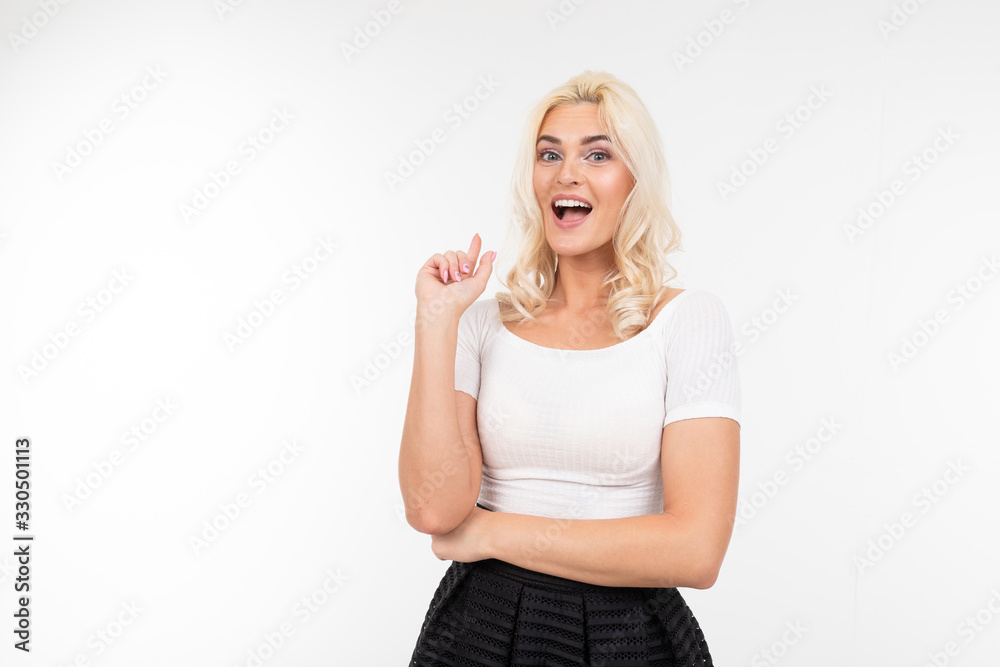 charming flirtatious girl in a white t-shirt with a layout smiles on a white background isolated studio charming flirtatious girl in a white t-shirt with a layout smiles on a white background isolated studio