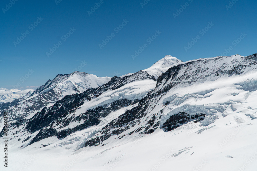 Panoramic view on winter snowy mountains at nice sunny evening. Panoramic view on winter snowy mountains at nice sunny evening.