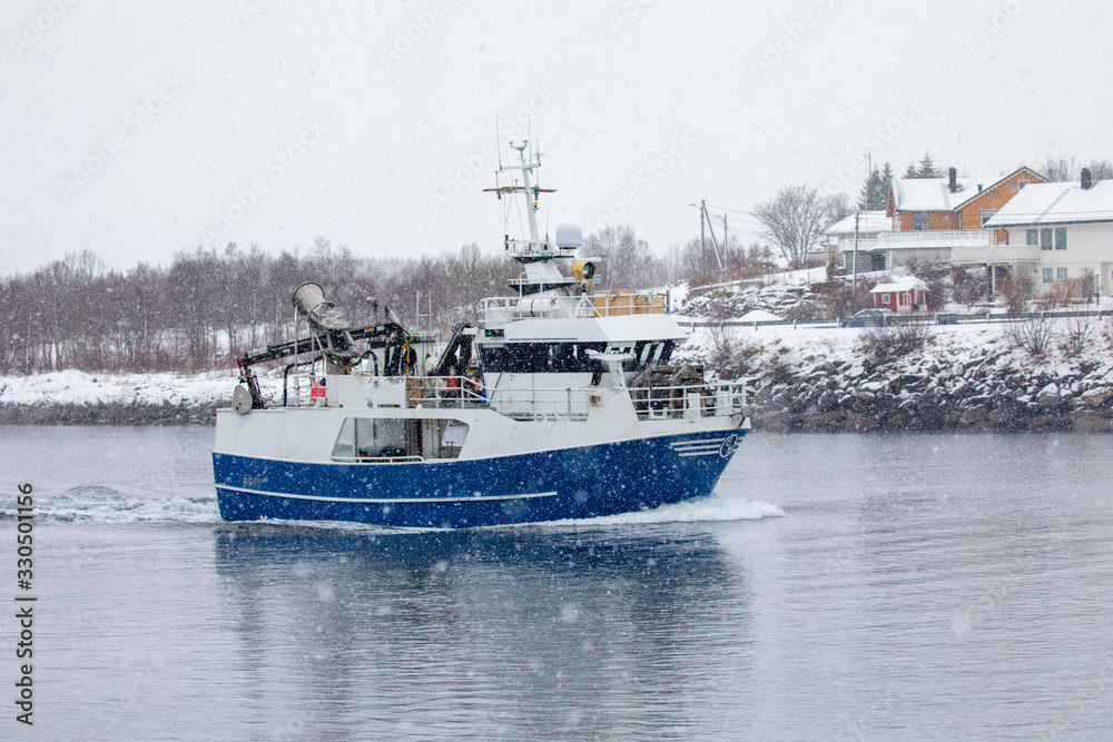 Fishing boat through Brønnøysundet in heavy snow weather