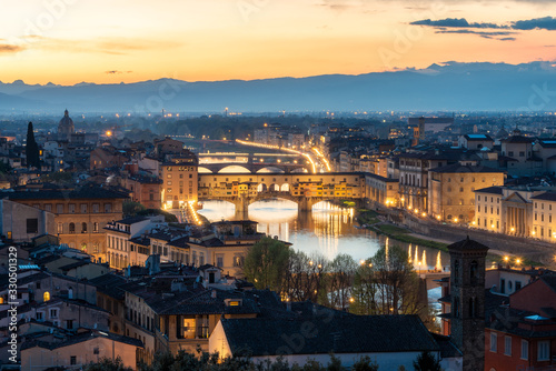 Amazing panoramic night view of Florence city, Italy with the river Arno and Ponte Vecchio.