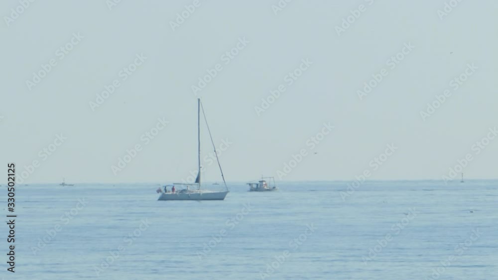 Sailboat and Maritime Traffic Sailing on Open Sea, Sunny Day. Static. Sailboat and Maritime Traffic Sailing on Open Sea, Sunny Day. Static.
