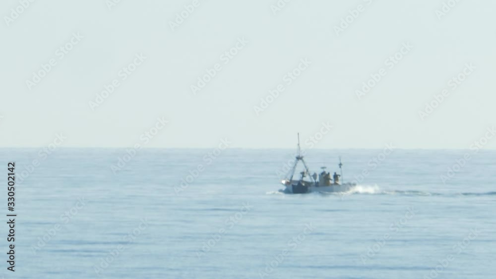 Isolated Small Fishing Boat Sailing in Open Sea SLOMO Isolated Small Fishing Boat Sailing in Open Sea SLOMO