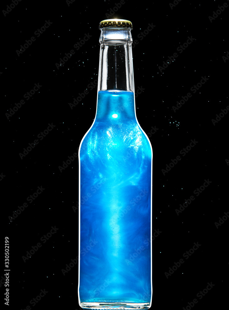 Blue carbonated alcoholic drink in a glass bottle saturated with food-grade pearlescent suspension Blue carbonated alcoholic drink in a glass bottle saturated with food-grade pearlescent suspension