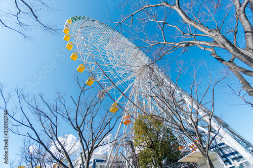 Tempozan giant ferris wheel in Osaka, Japan with  bright blue sky photo