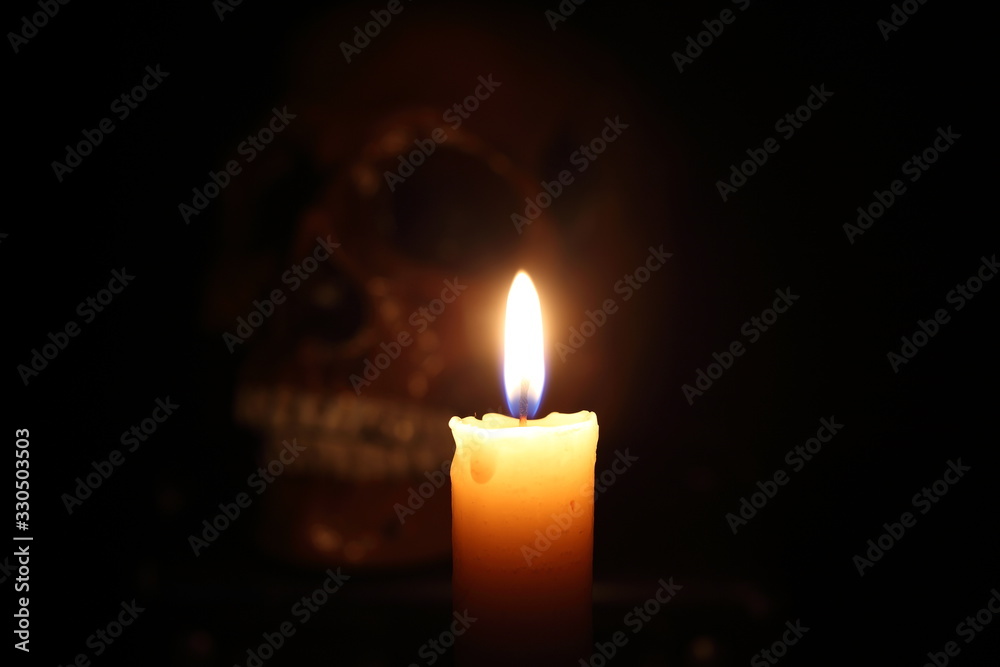 Skull and candle. Black magic. Focus on candle Skull and candle. Black magic. Focus on candle