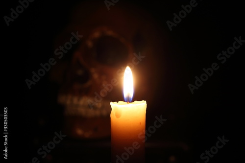 Skull and candle. Black magic. Focus on candle