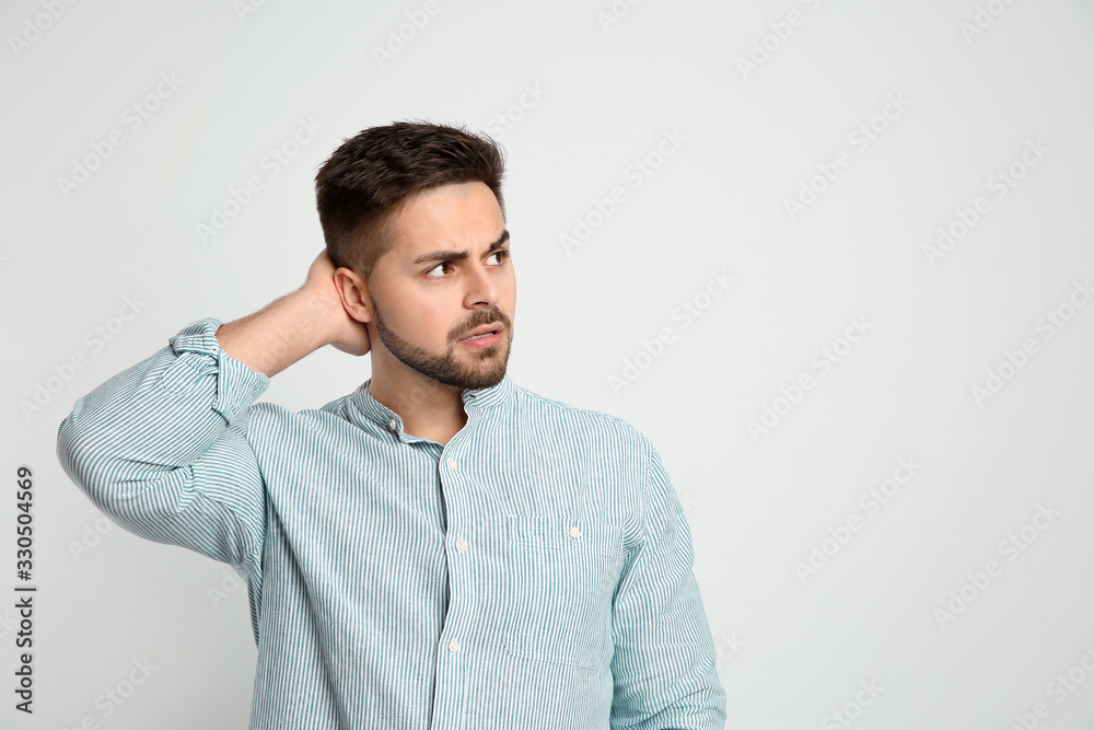 Pensive man on light background, space for text. Thinking about answer to question Pensive man on light background, space for text. Thinking about answer to question