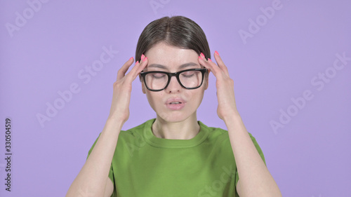 The Tired Young Woman having Headache on Purple Background