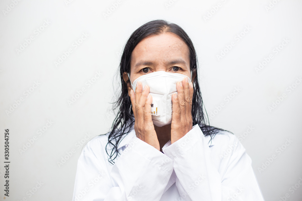 Elderly asian women wearing KN95 masks covering their mouths and noses preventing coronavirus and pm 2.5 dust on white background.