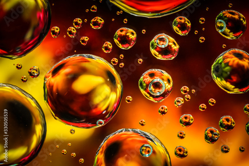 Vivid color of water drop reflection refraction of flowers on transparent glass