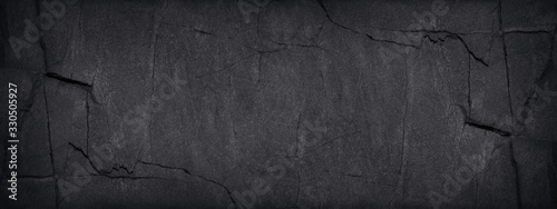 Panel kuchenny z motywem Black grunge background. Dark gray stone background with copy space. Black grunge banner with rock texture. Rock background with cracked surface.