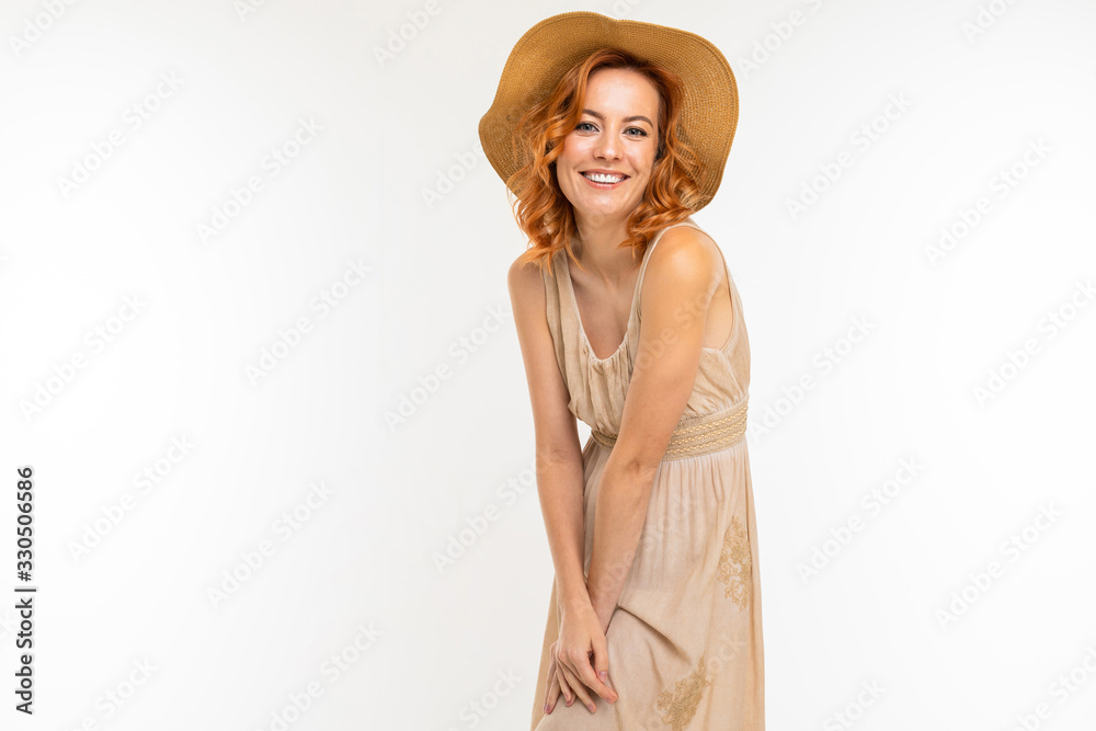 Cheerful woman with fair red hair in beautiful dress smiles, picture isolated on white background Cheerful woman with fair red hair in beautiful dress smiles, picture isolated on white background