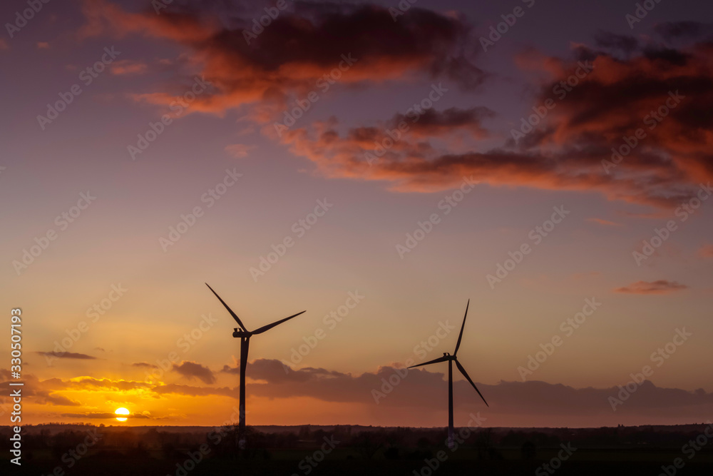 two windmills at sunset landscape view