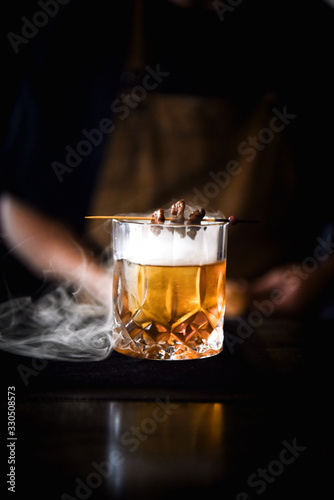 Smoking Cocktail on a bar with a bartender