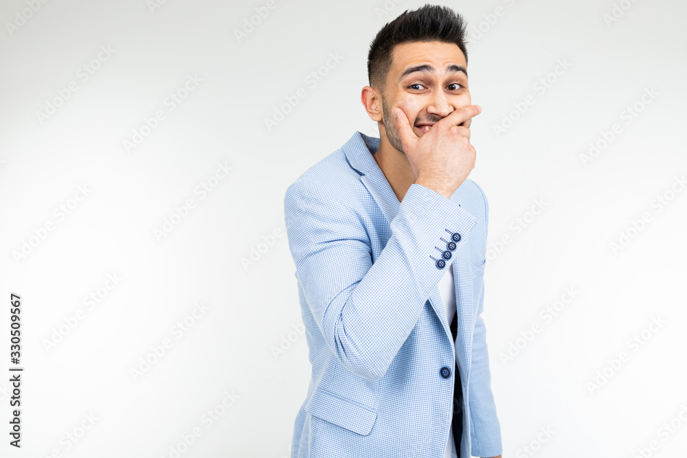 serious man in a jacket joked and laughs on a white studio background serious man in a jacket joked and laughs on a white studio background