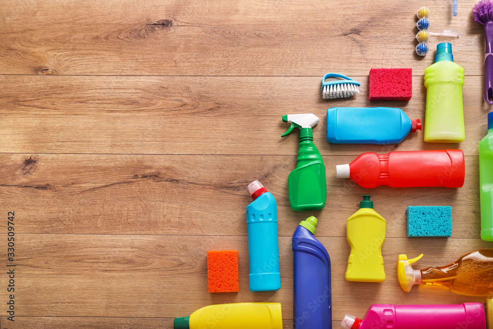 Many cleaning products on wood background. Top view