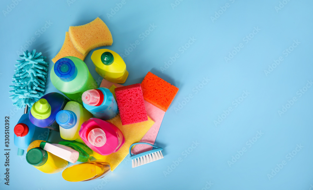 Many cleaning products on blue background. Top view