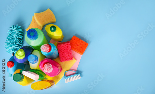 Many cleaning products on blue background. Top view