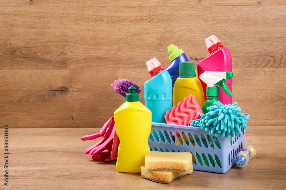 Many cleaning products on wood background