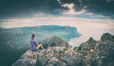 Girl sitting on a rocky cliff