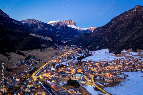 Night aerial view of Pozza di Fassa, a commune in Trentino at the northern Italia. Val di Fassa, Dolomiti