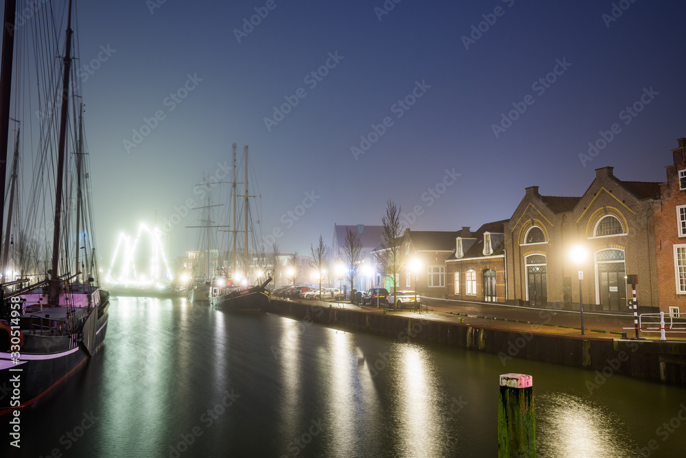 Harlingen, Netherlands - January 09, 2020. Boat docked in downtown at night