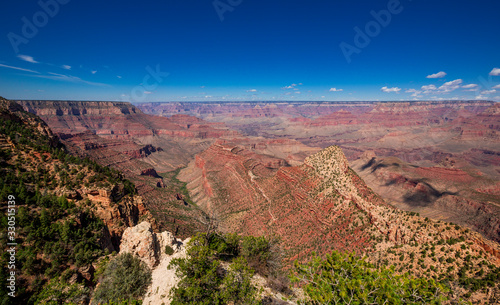 Red rocks of Grand Canyon with sun and blue sky, USA