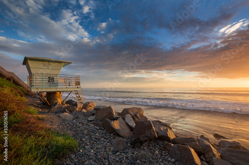 Sunset at beach od West Coast in California with lifeguard tower, USA photo