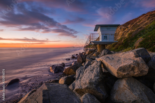 Sunset at beach od West Coast in California with lifeguard tower, USA