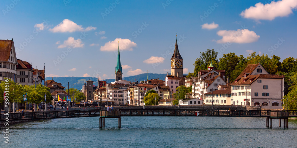 Panoramic view of famous Fraumunster and Church of St Peter and river Limmat Old Town of Zurich, the largest city in Switzerland Panoramic view of famous Fraumunster and Church of St Peter and river Limmat Old Town of Zurich, the largest city in Switzerland