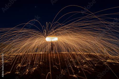 Burning Steel Wool spinning. Showers of glowing sparks from spinning steel wool