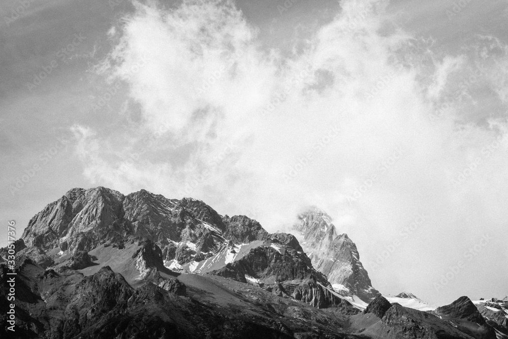 Close up of snow mountain with bright blue sky in monochrome
