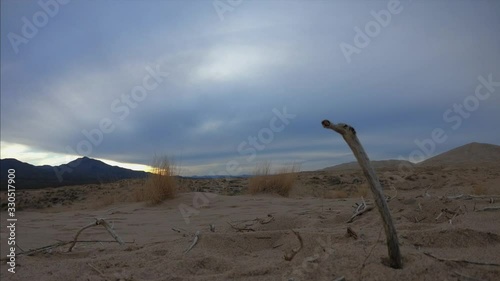 Beautiful time lapse of brown dunes and clouds in the Mojave desert of California, USA. Beauty landscape with desert and cloudy sky at Mojave. Scenic desertic at cloudy day of winter.