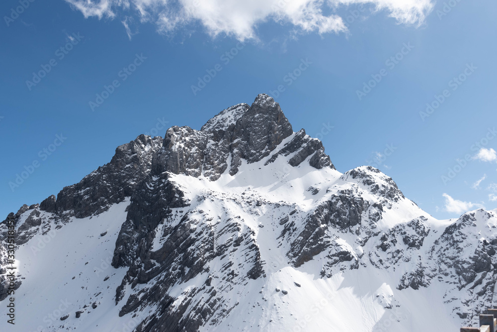 Close up of snow mountain with bright blue sky