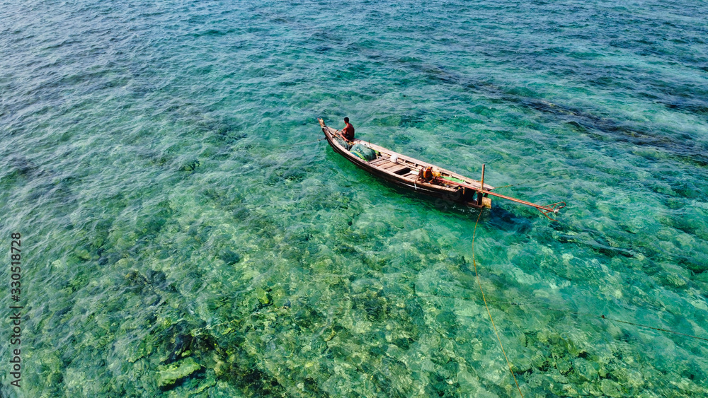 NGWE SAUNG/MYANMAR - MARCH 14, 2020 : Burmese fishermen bear caught fish in baskets on the beach Ngwe Saung Myanmar NGWE SAUNG/MYANMAR - MARCH 14, 2020 : Burmese fishermen bear caught fish in baskets on the beach Ngwe Saung Myanmar