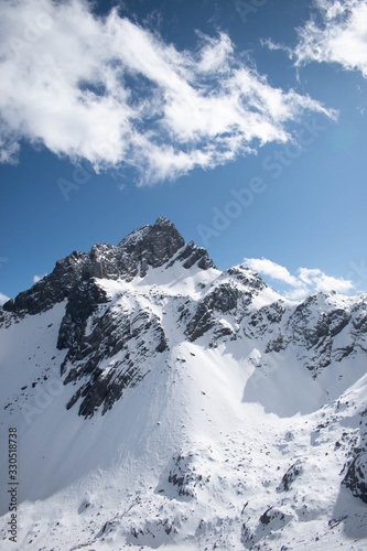 Fototapeta Naklejka Na Ścianę i Meble -  Close up of snow mountain with bright blue sky
