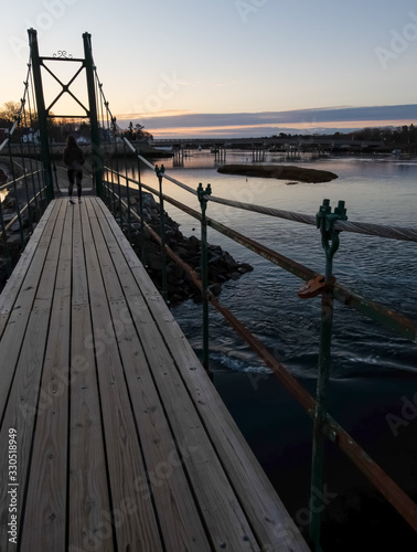 Sunrise on Wiggly Bridge in York Harbor with solo female - York, Maine.