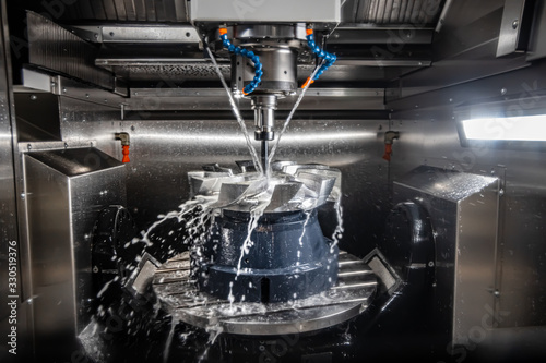 Metalworking CNC lathe milling machine. Cutting metal modern processing technology. photo